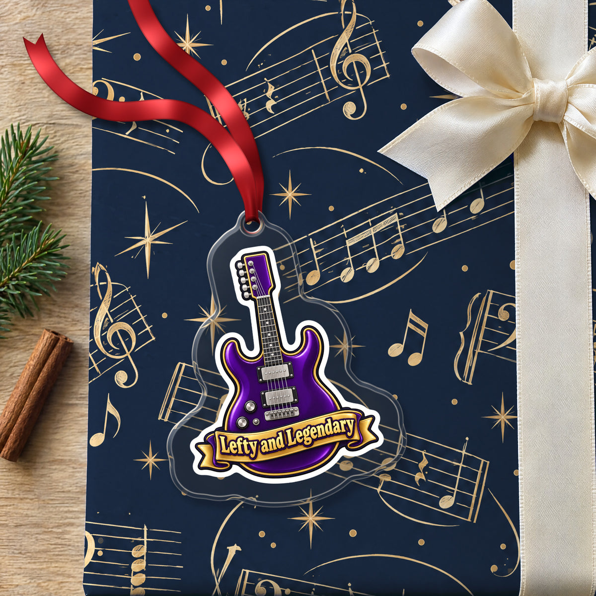 Lefty and Legendary Electric Guitar clear acrylic Christmas ornament lying on a gift wrapped in Rhythm and Beat music wrapping paper
