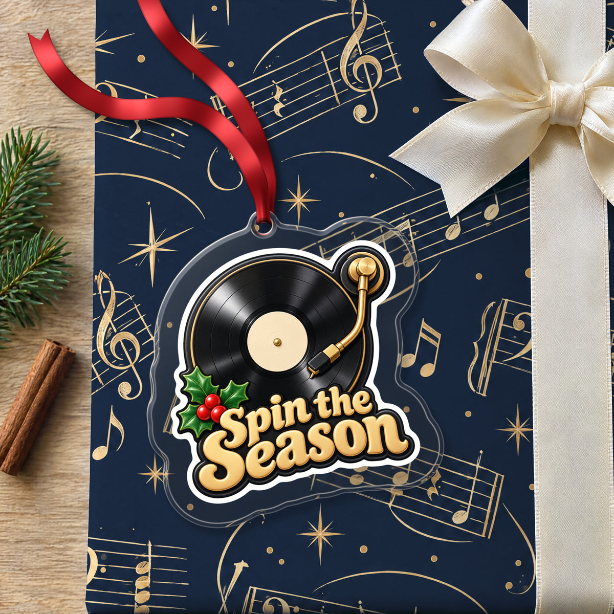 Spin the Season Vinyl Record clear acrylic Christmas ornament lying on a gift wrapped in Rhythm and Beat music wrapping paper