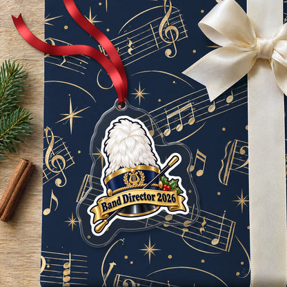 Band Director 2026 clear acrylic Christmas ornament lying on a gift wrapped in Rhythm and Beat music wrapping paper
