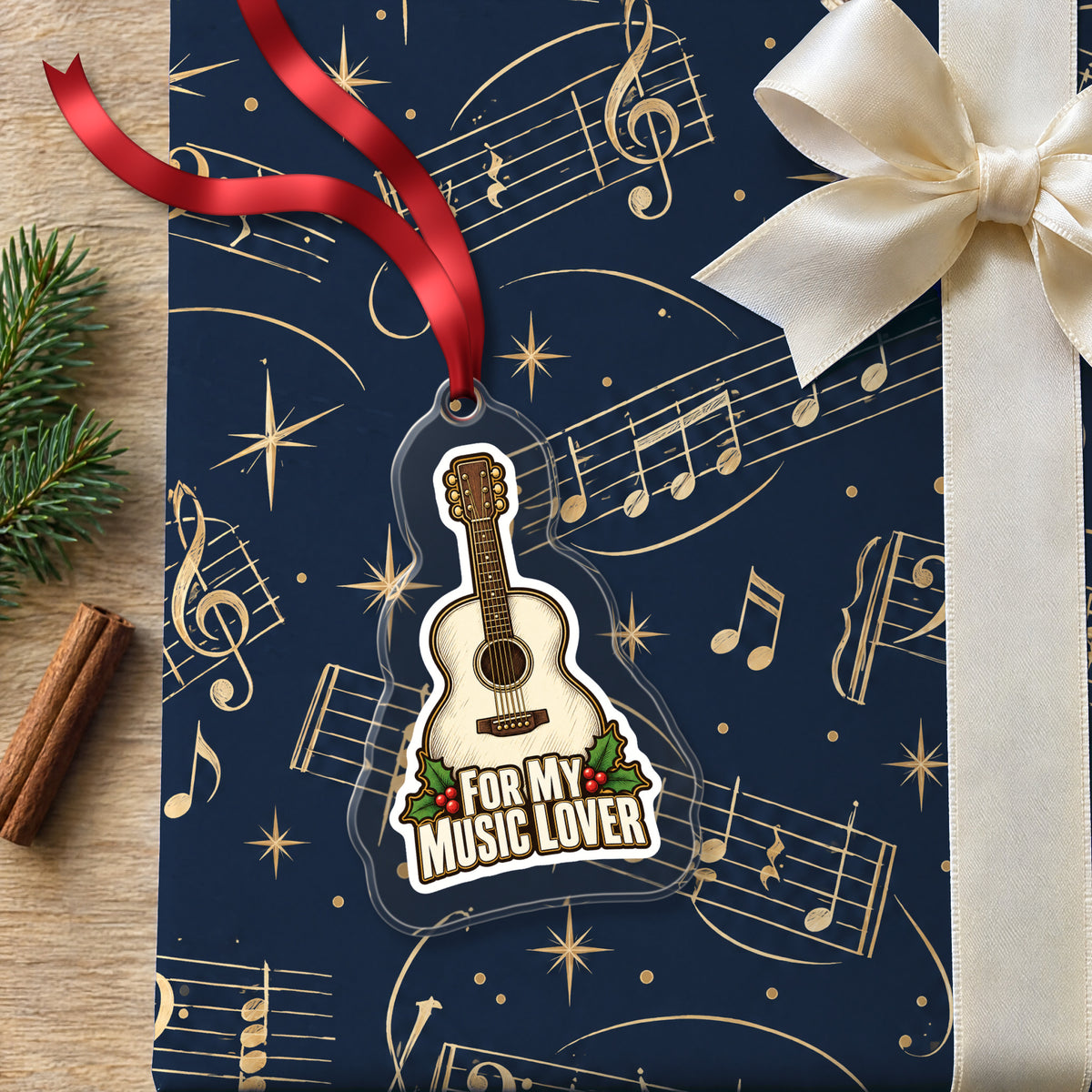 For My Music Lover Acoustic Guitar clear acrylic Christmas ornament lying on a gift wrapped in Rhythm and Beat music wrapping paper