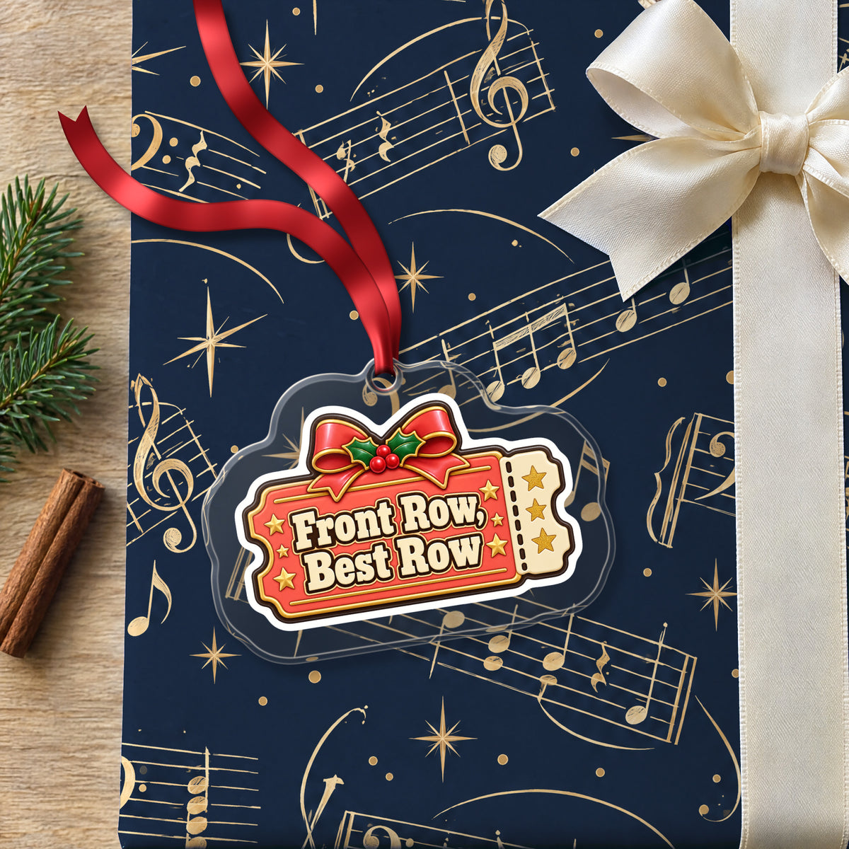 Front Row, Best Row Concert Ticket clear acrylic Christmas ornament lying on a gift wrapped in Rhythm and Beat music wrapping paper