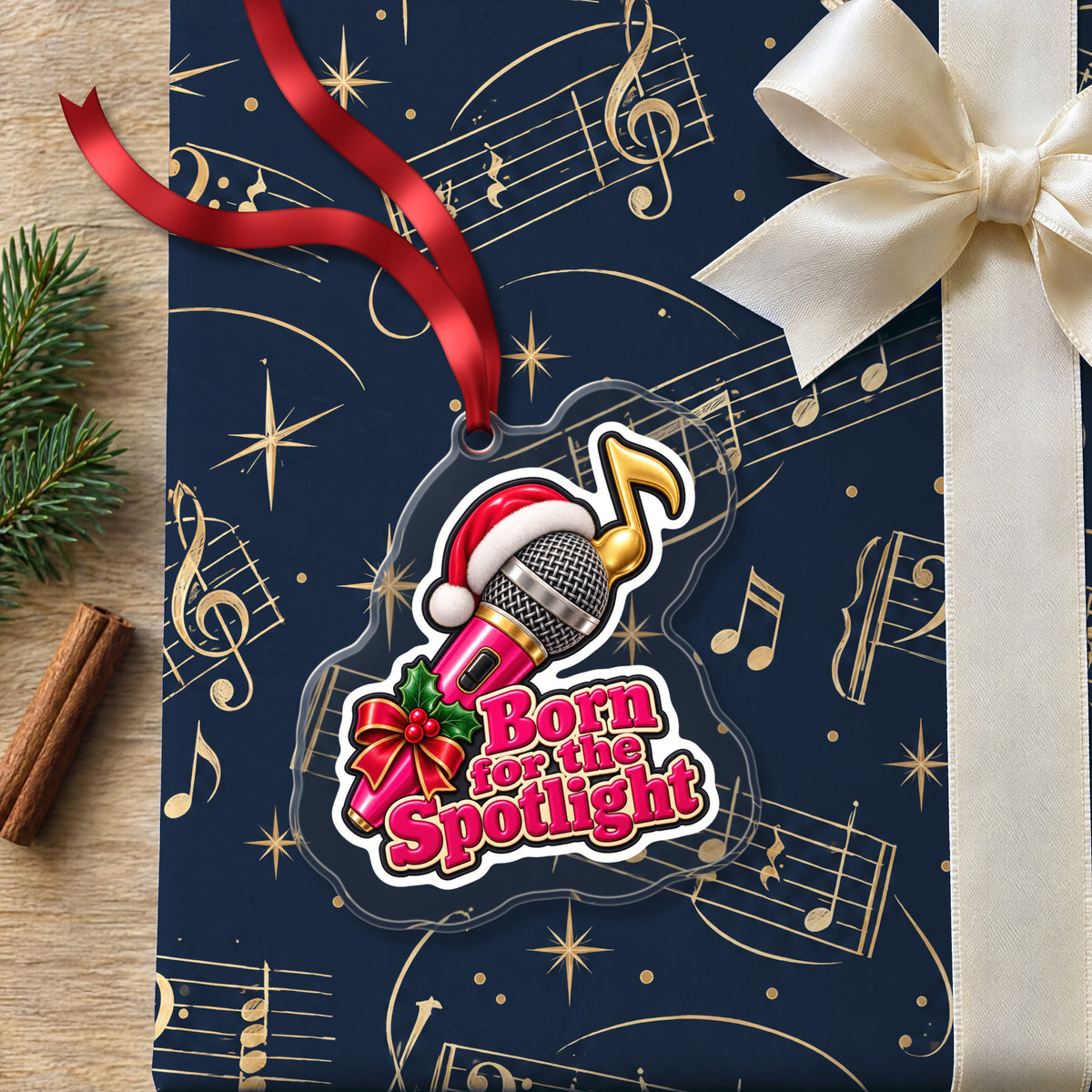 Born for the Spotlight Karaoke Mic clear acrylic Christmas ornament lying on a gift wrapped in Rhythm and Beat music wrapping paper