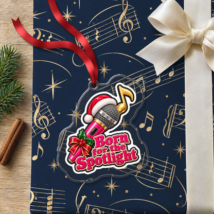 Born for the Spotlight Karaoke Mic clear acrylic Christmas ornament lying on a gift wrapped in Rhythm and Beat music wrapping paper