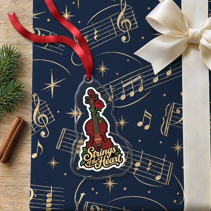 Strings of the Heart Violin clear acrylic Christmas ornament lying on a gift wrapped in Rhythm and Beat music wrapping paper