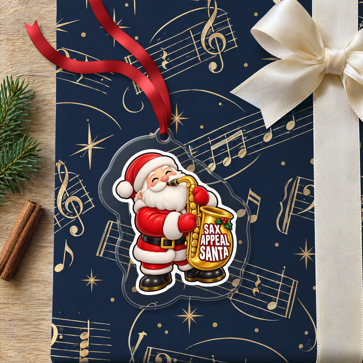 Sax Appeal Santa Saxophone clear acrylic Christmas ornament lying on a gift wrapped in Rhythm and Beat music wrapping paper