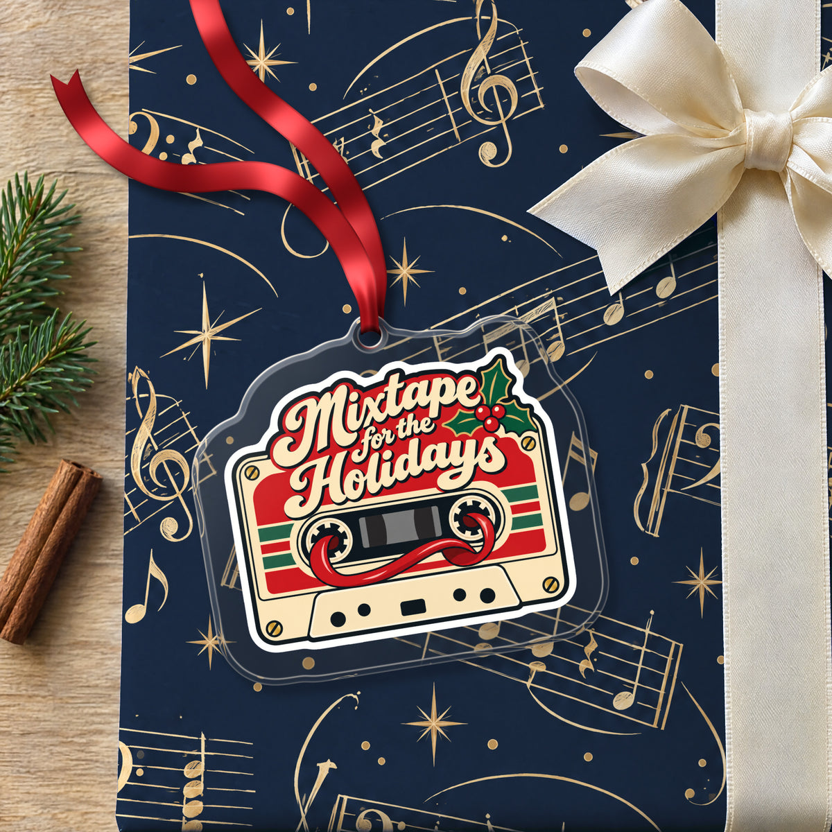 Mixtape for the Holidays Cassette clear acrylic Christmas ornament lying on a gift wrapped in Rhythm and Beat music wrapping paper