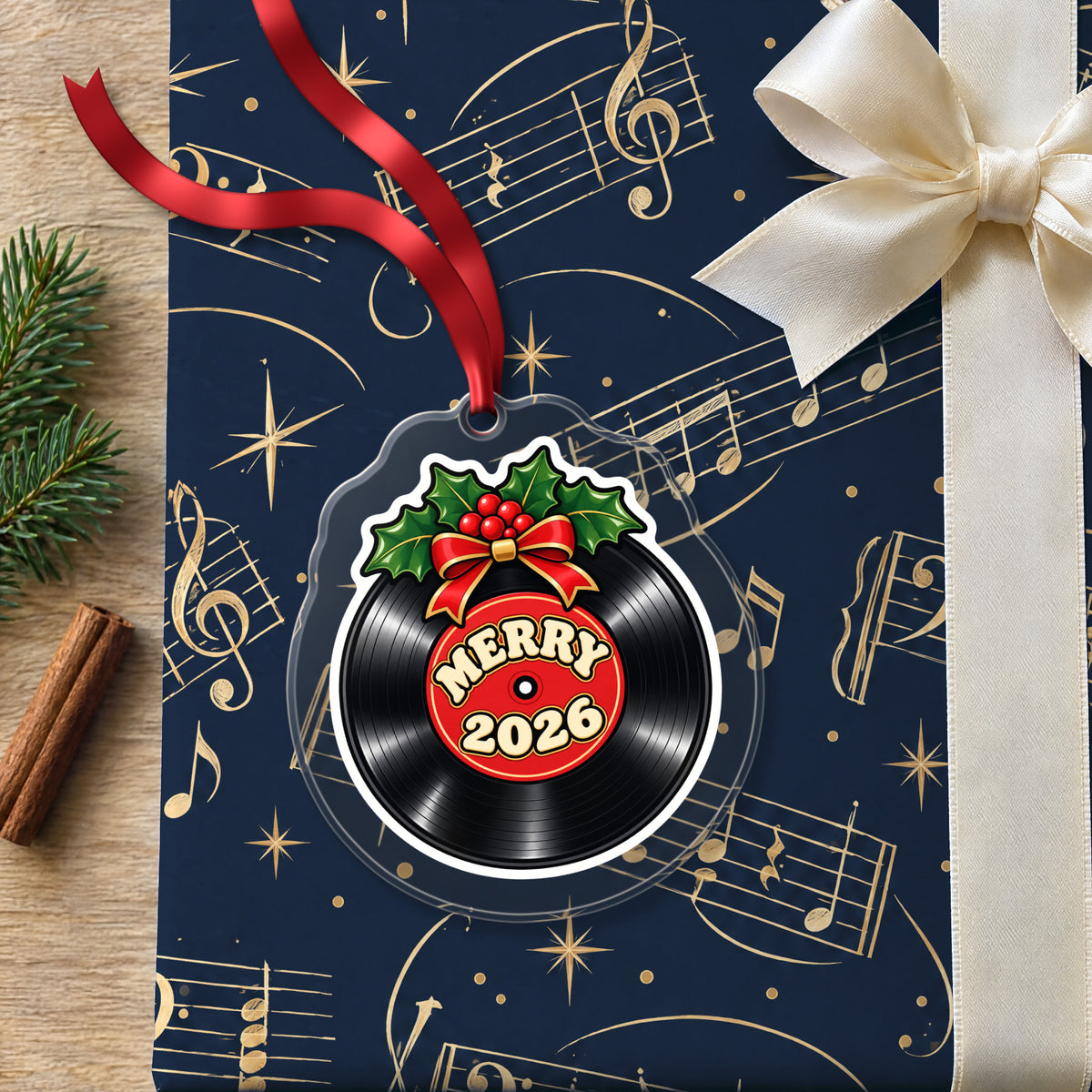 Merry 2026 Vinyl Record clear acrylic Christmas ornament lying on a gift wrapped in Rhythm and Beat music wrapping paper
