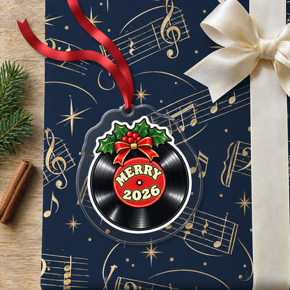 Merry 2026 Vinyl Record clear acrylic Christmas ornament lying on a gift wrapped in Rhythm and Beat music wrapping paper
