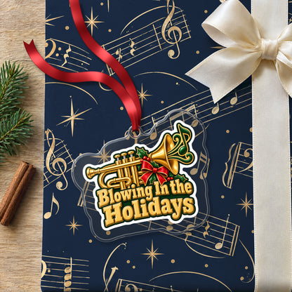 Blowing In the Holidays Trumpet clear acrylic Christmas ornament lying on a gift wrapped in Rhythm and Beat music wrapping paper