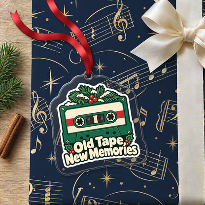 Old Tape, New Memories Cassette clear acrylic Christmas ornament lying on a gift wrapped in Rhythm and Beat music wrapping paper