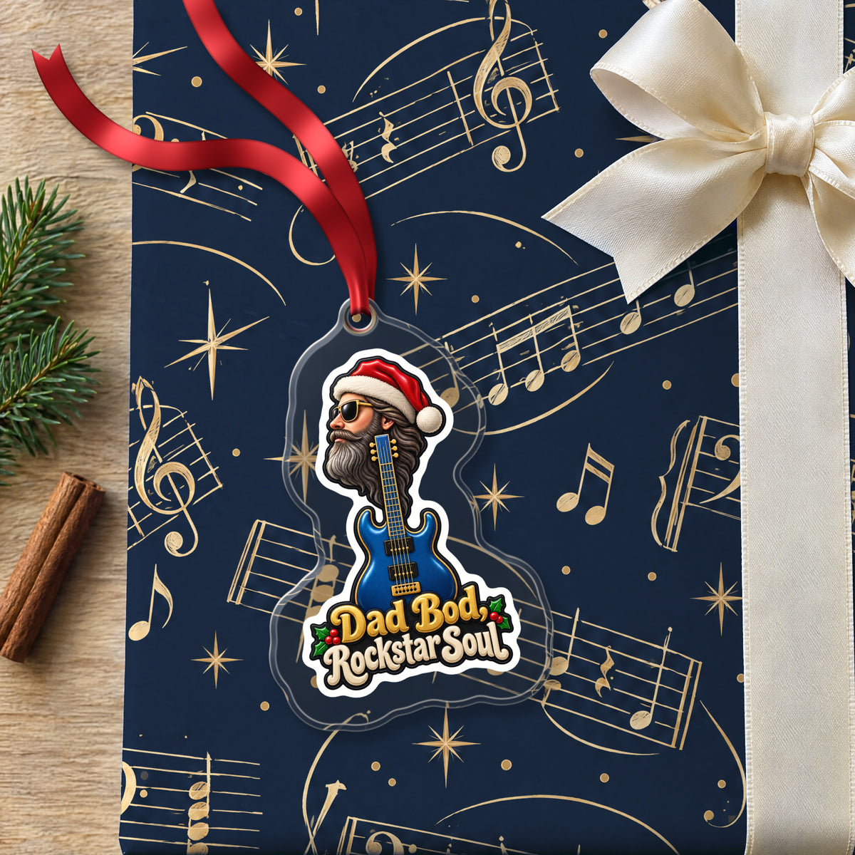 Dad Bod, Rockstar Soul Guitar clear acrylic Christmas ornament lying on a gift wrapped in Rhythm and Beat music wrapping paper