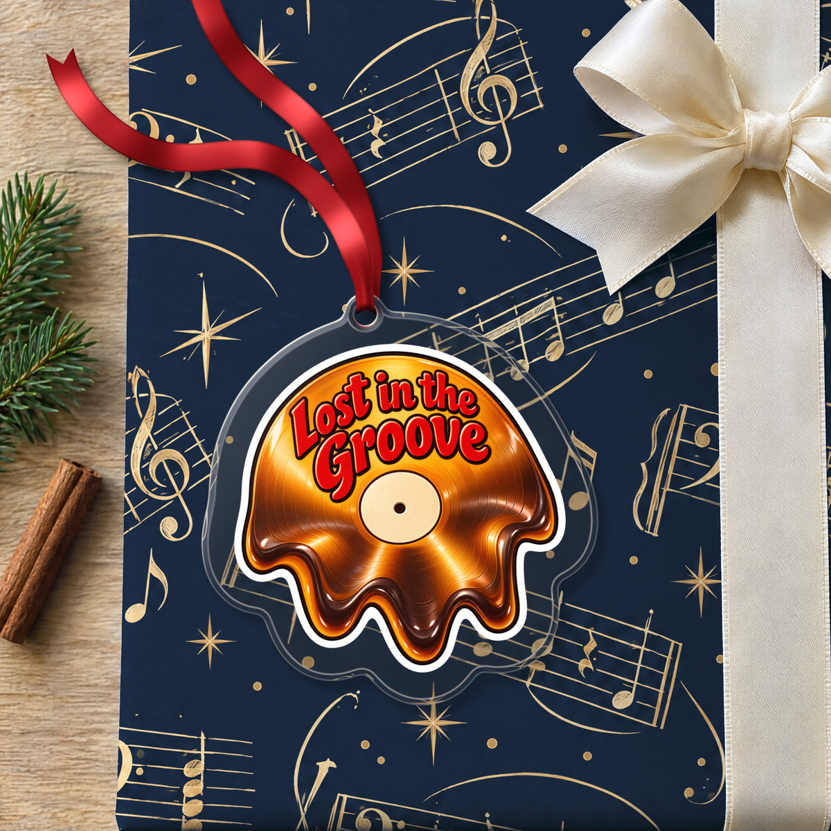 Lost in the Groove Melting Vinyl clear acrylic Christmas ornament lying on a gift wrapped in Rhythm and Beat music wrapping paper