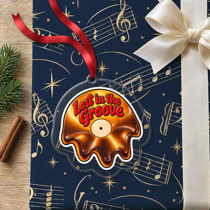 Lost in the Groove Melting Vinyl clear acrylic Christmas ornament lying on a gift wrapped in Rhythm and Beat music wrapping paper