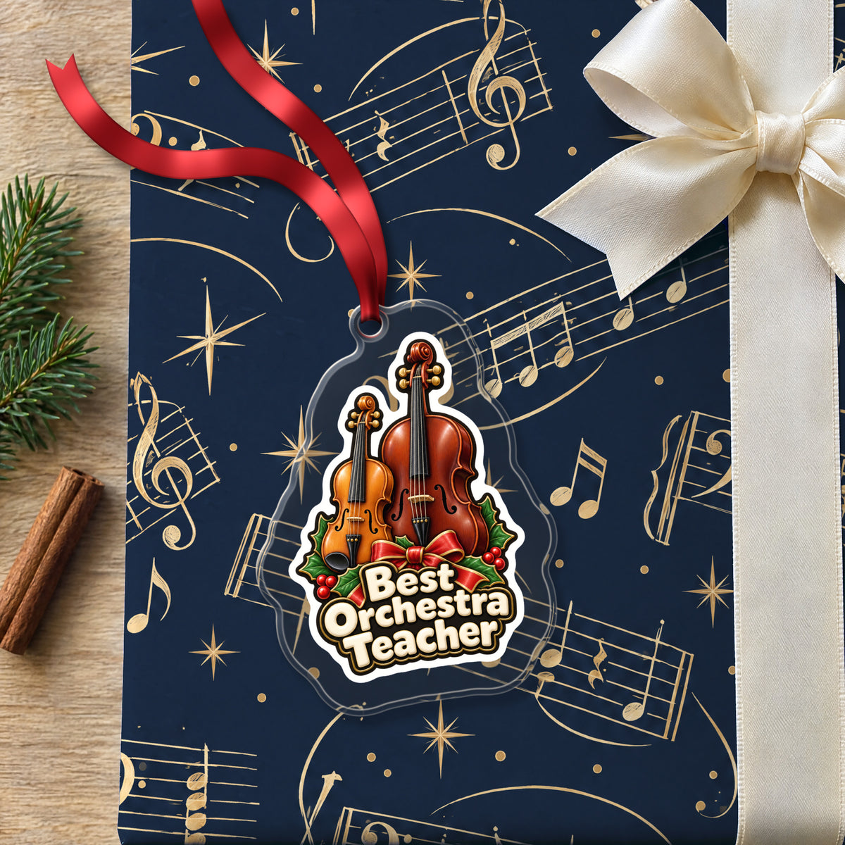 Best Orchestra Teacher clear acrylic Christmas ornament lying on a gift wrapped in Rhythm and Beat music wrapping paper