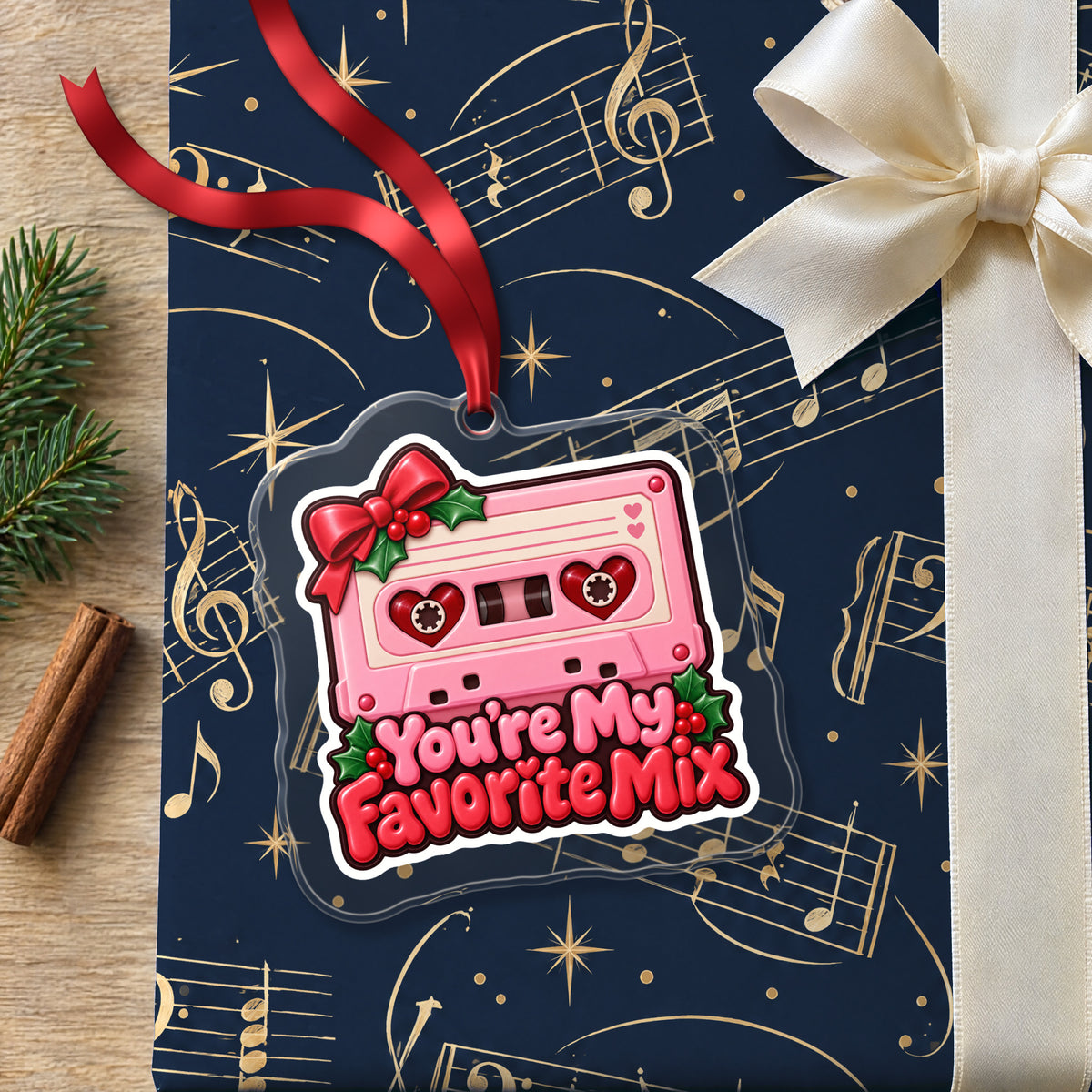 You're My Favorite Mix Cassette clear acrylic Christmas ornament lying on a gift wrapped in Rhythm and Beat music wrapping paper