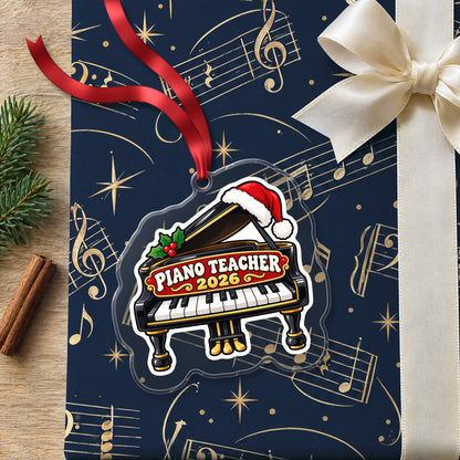 Piano Teacher 2026 clear acrylic Christmas ornament lying on a gift wrapped in Rhythm and Beat music wrapping paper