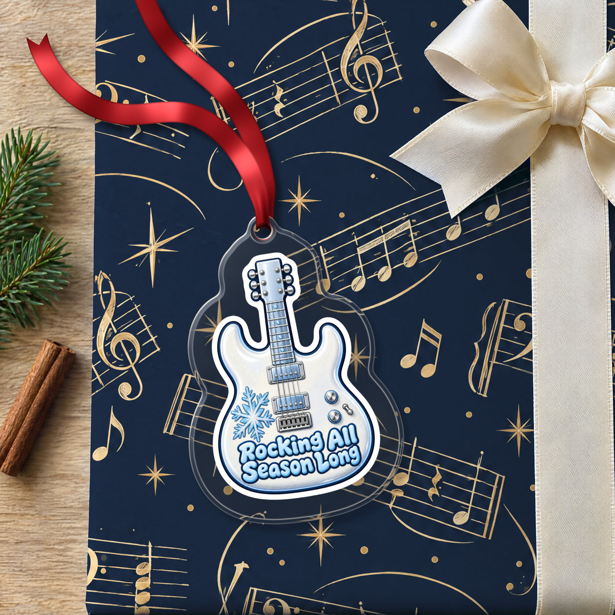 Rocking All Season Electric Guitar clear acrylic Christmas ornament lying on a gift wrapped in Rhythm and Beat music wrapping paper
