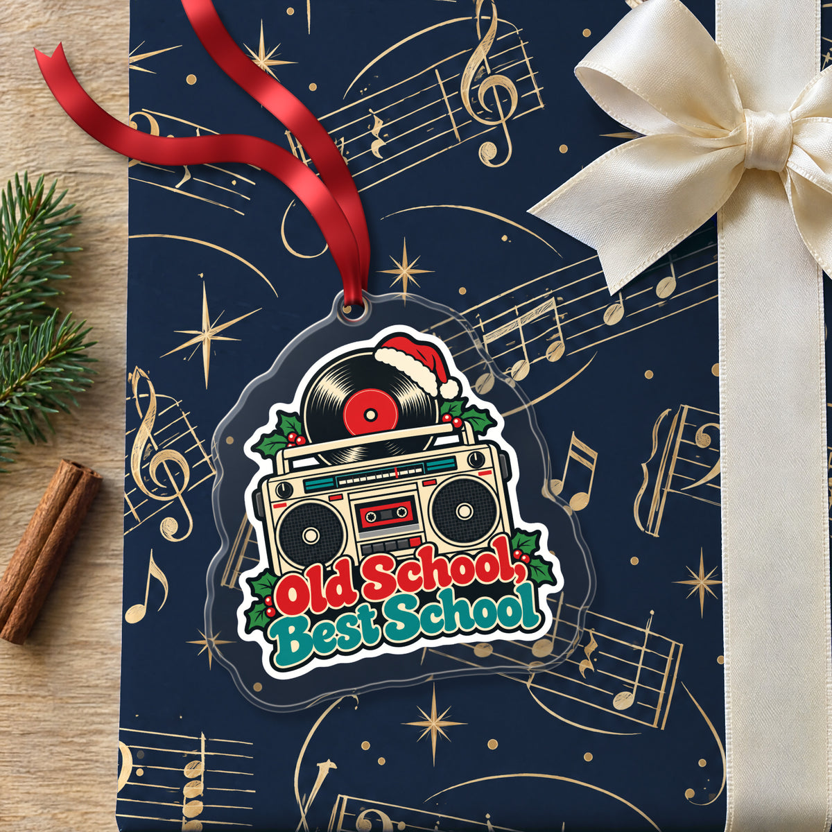 Old School, Best School Boombox clear acrylic Christmas ornament lying on a gift wrapped in Rhythm and Beat music wrapping paper
