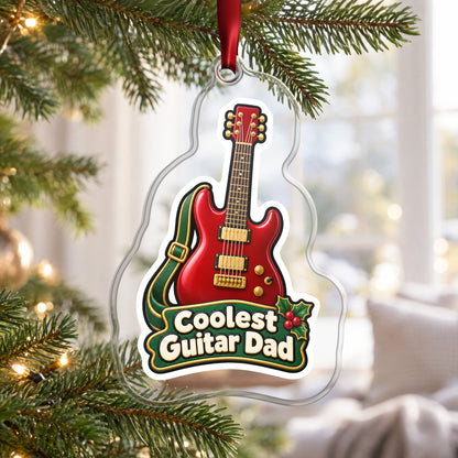 Coolest Guitar Dad clear acrylic Christmas ornament hanging on a Christmas tree by a bright window
