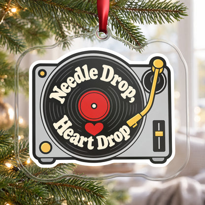 Needle Drop, Heart Drop Turntable clear acrylic Christmas ornament hanging on a Christmas tree by a bright window