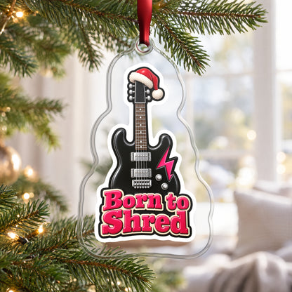 Born to Shred Electric Guitar clear acrylic Christmas ornament hanging on a Christmas tree by a bright window