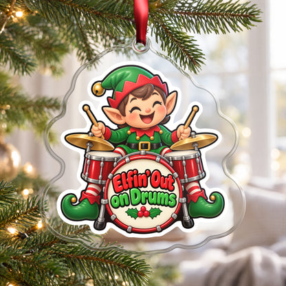 Elfin' Out on Drums Elf Drummer clear acrylic Christmas ornament hanging on a Christmas tree by a bright window
