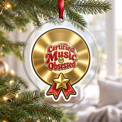 Certified Music Obsessed Gold Record clear acrylic Christmas ornament hanging on a Christmas tree by a bright window