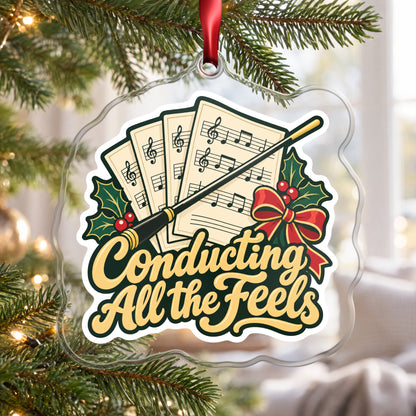 Conducting All the Feels Baton clear acrylic Christmas ornament hanging on a Christmas tree by a bright window