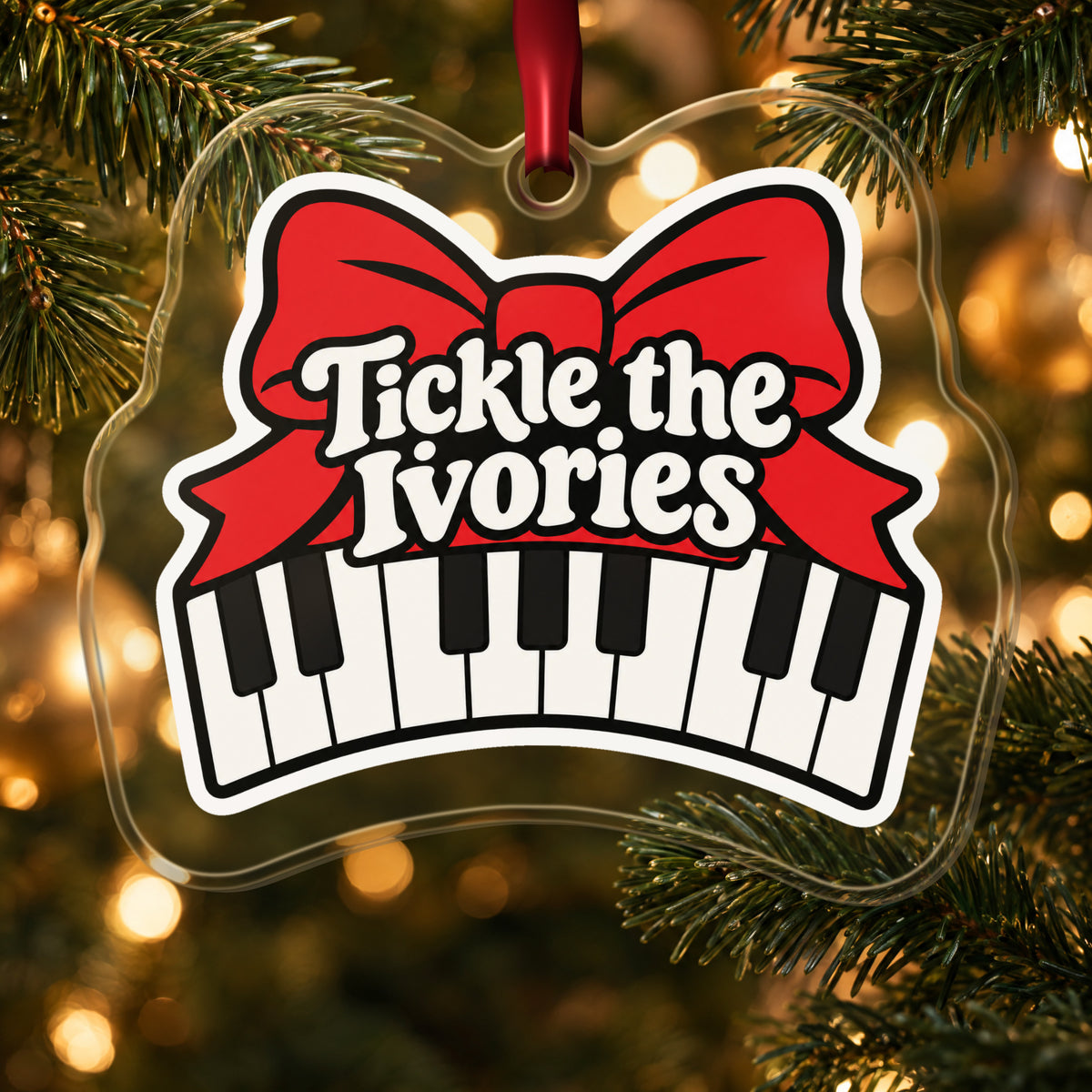 Tickle the Ivories Piano Keys clear acrylic Christmas ornament hanging on a lit Christmas tree with warm gold lights