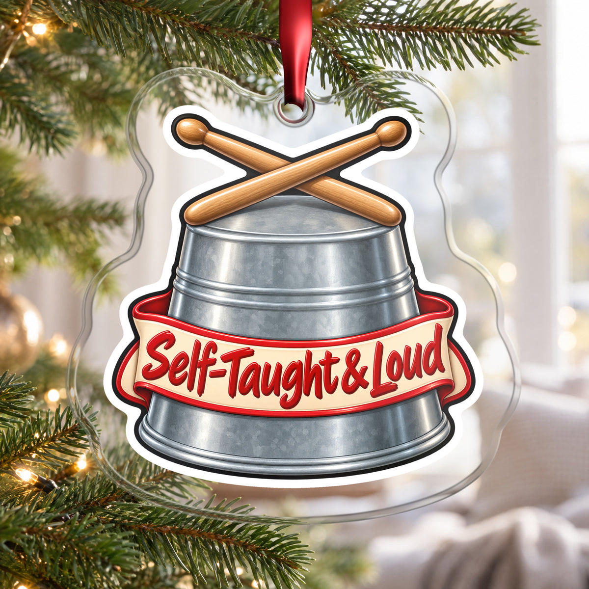 Self-Taught & Loud Bucket Drummer clear acrylic Christmas ornament hanging on a Christmas tree by a bright window