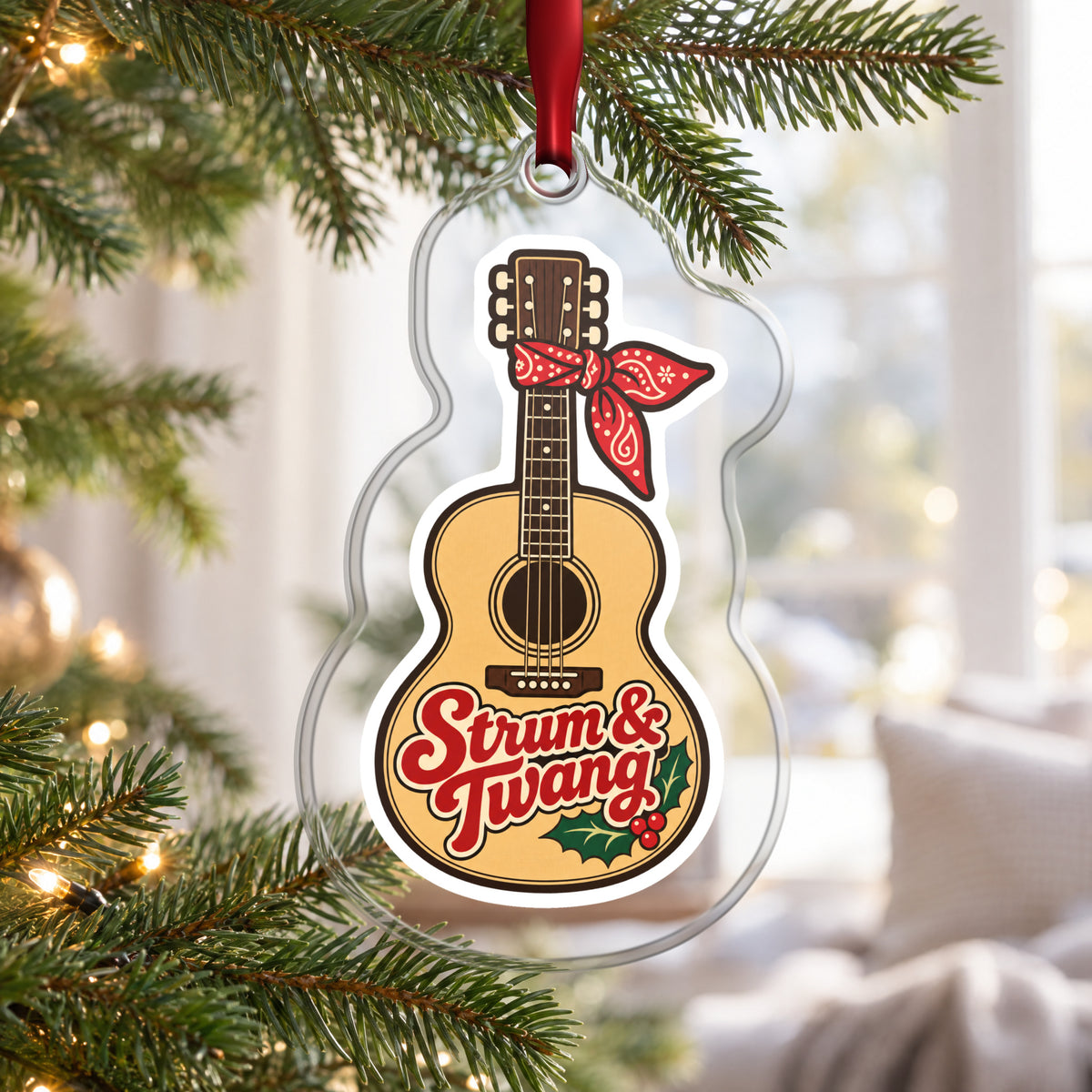 Strum & Twang Country Guitar clear acrylic Christmas ornament hanging on a Christmas tree by a bright window