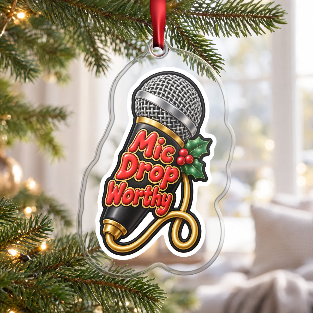 Mic Drop Worthy Microphone clear acrylic Christmas ornament hanging on a Christmas tree by a bright window