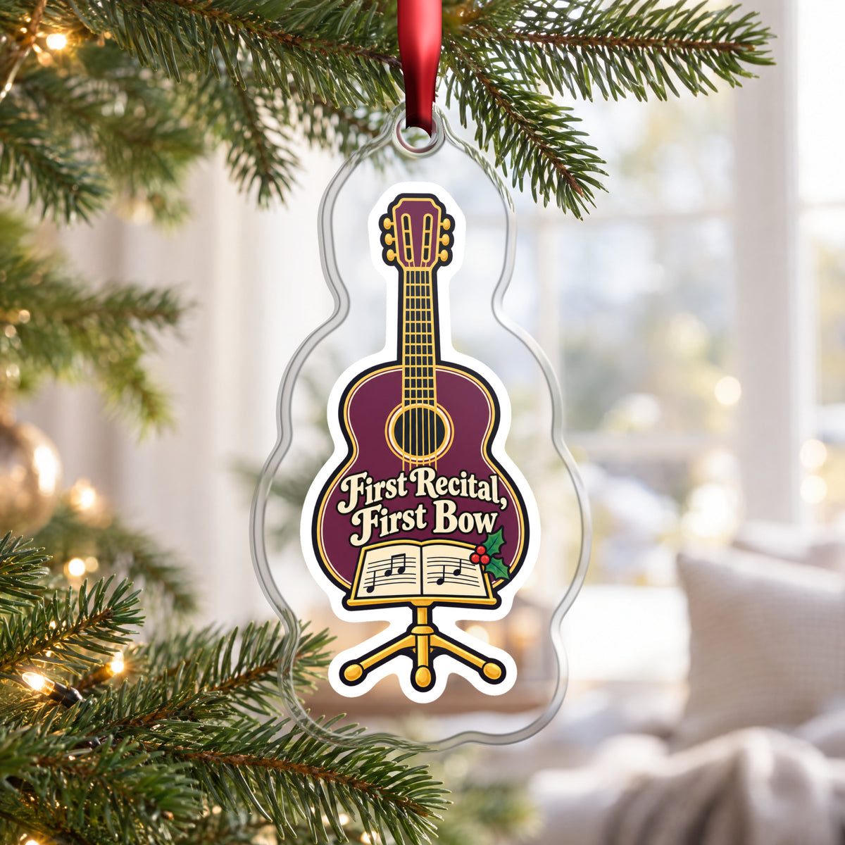 First Recital Acoustic Guitar clear acrylic Christmas ornament hanging on a Christmas tree by a bright window