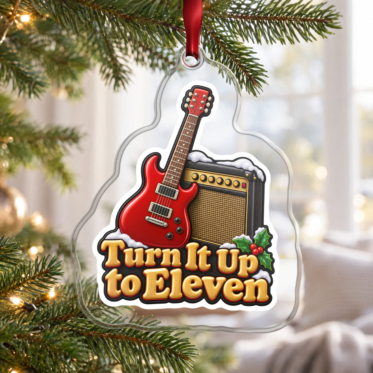 Turn It Up to Eleven Guitar and Amp clear acrylic Christmas ornament hanging on a Christmas tree by a bright window