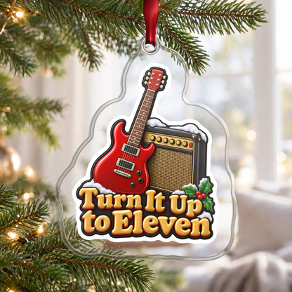 Turn It Up to Eleven Guitar and Amp clear acrylic Christmas ornament hanging on a Christmas tree by a bright window
