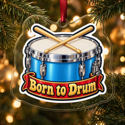 Born to Drum Snare Drum clear acrylic Christmas ornament hanging on a lit Christmas tree with warm gold lights