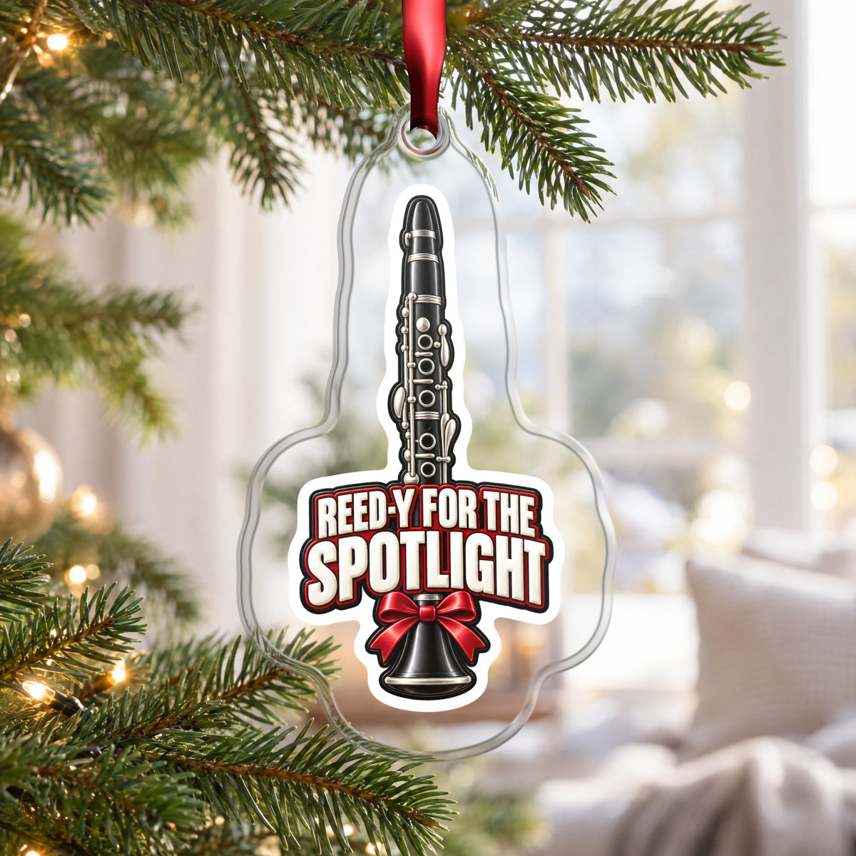 Reed-y for the Spotlight Clarinet clear acrylic Christmas ornament hanging on a Christmas tree by a bright window