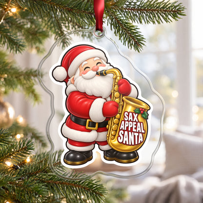 Sax Appeal Santa Saxophone clear acrylic Christmas ornament hanging on a Christmas tree by a bright window
