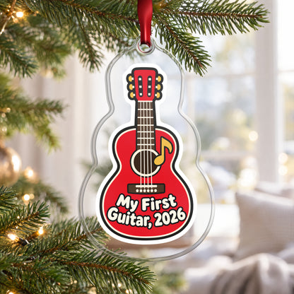 My First Guitar 2026 clear acrylic Christmas ornament hanging on a Christmas tree by a bright window