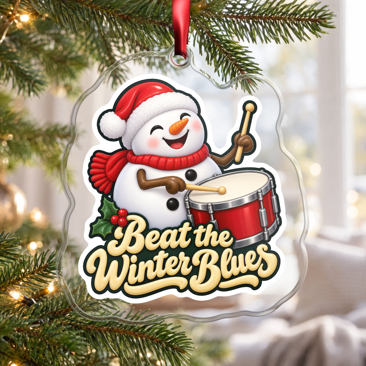 Beat the Winter Blues Snowman Drummer clear acrylic Christmas ornament hanging on a Christmas tree by a bright window
