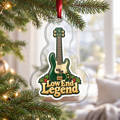 Low End Legend Bass Guitar clear acrylic Christmas ornament hanging on a Christmas tree by a bright window