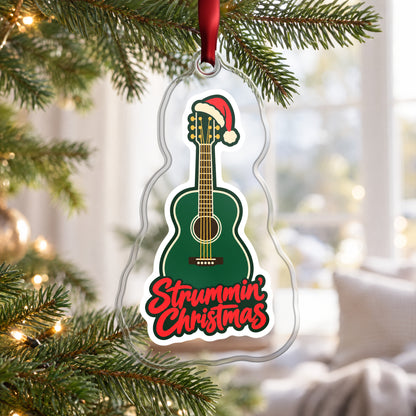 Strummin' Christmas Acoustic Guitar clear acrylic Christmas ornament hanging on a Christmas tree by a bright window