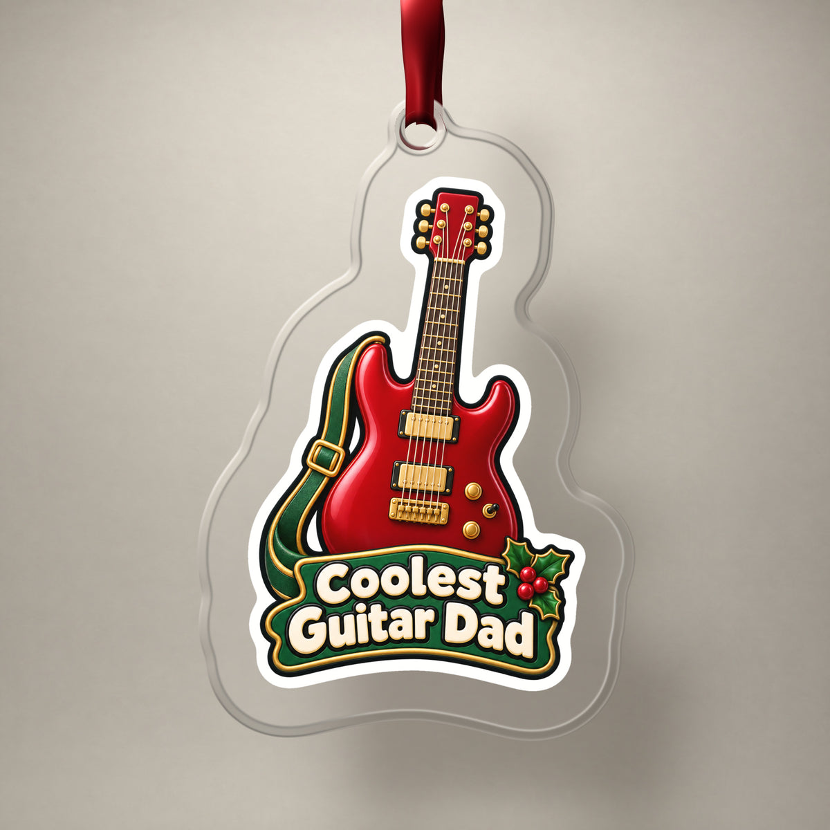 Coolest Guitar Dad clear acrylic Christmas ornament on a plain studio backdrop with its red ribbon