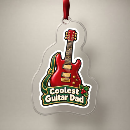 Coolest Guitar Dad clear acrylic Christmas ornament on a plain studio backdrop with its red ribbon