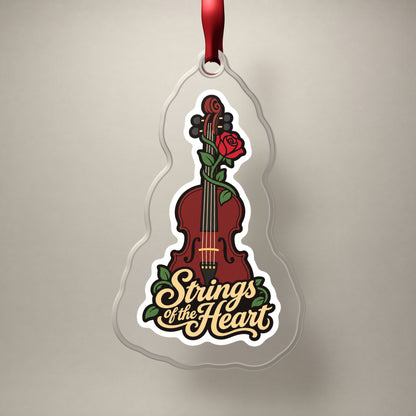 Strings of the Heart Violin clear acrylic Christmas ornament on a plain studio backdrop with its red ribbon