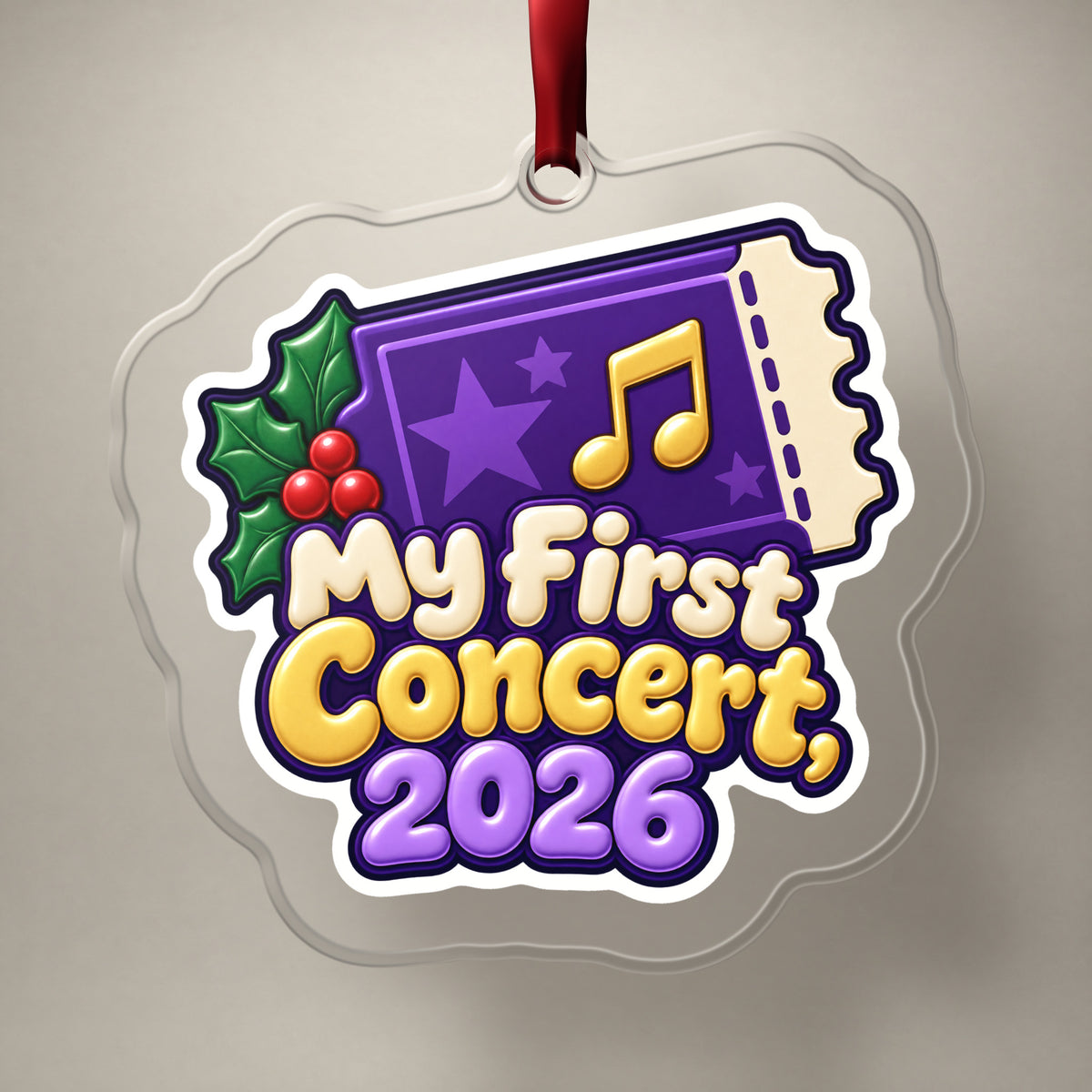 My First Concert 2026 Ticket clear acrylic Christmas ornament on a plain studio backdrop with its red ribbon