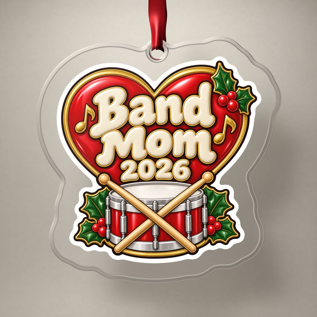 Band Mom 2026 clear acrylic Christmas ornament on a plain studio backdrop with its red ribbon