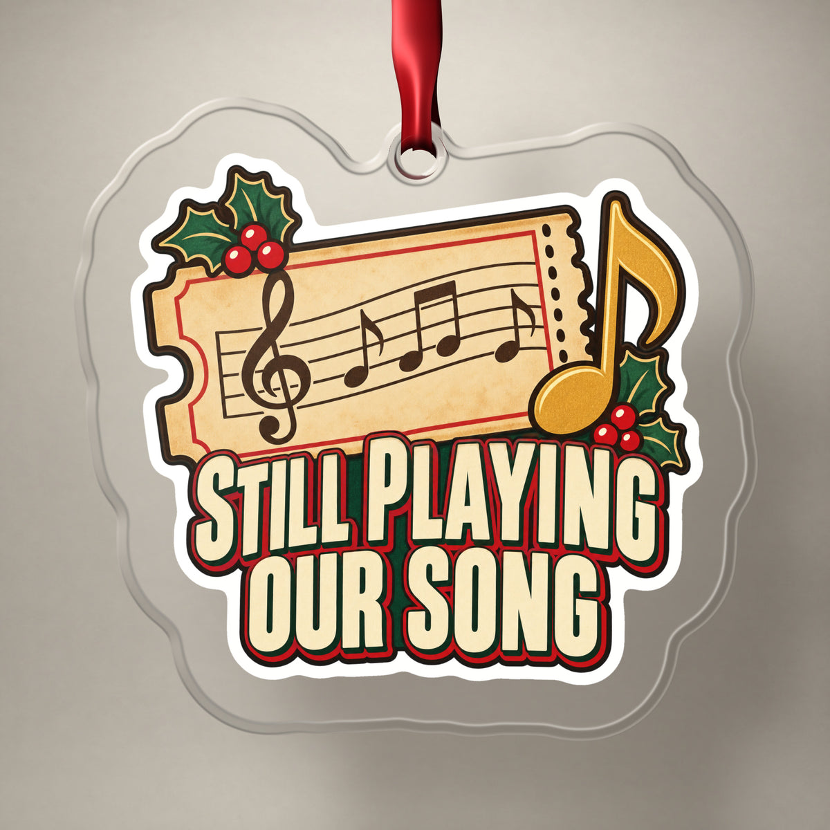 Still Playing Our Song Concert Ticket clear acrylic Christmas ornament on a plain studio backdrop with its red ribbon