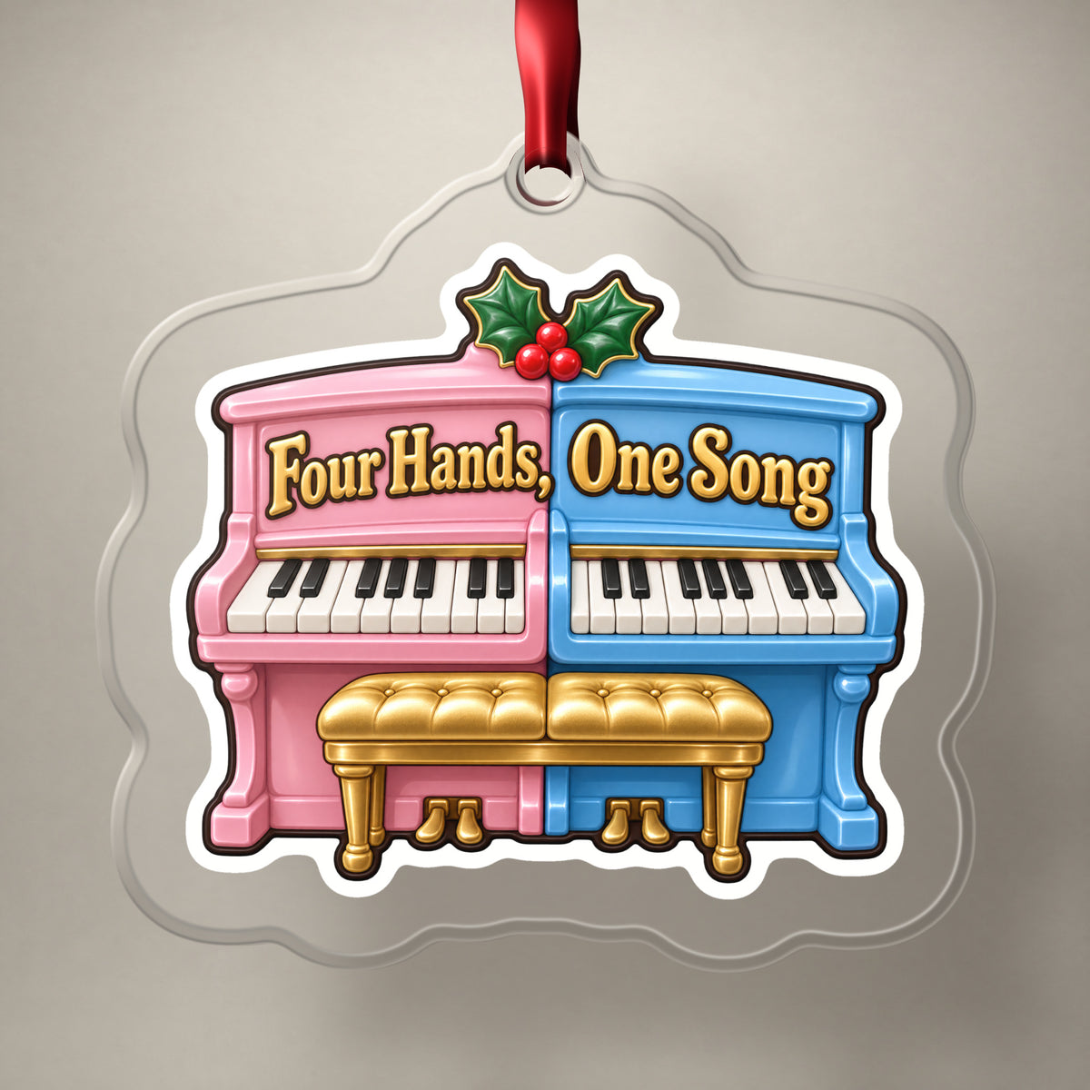 Four Hands, One Song Piano Duet clear acrylic Christmas ornament on a plain studio backdrop with its red ribbon