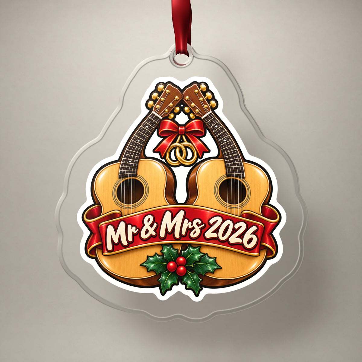 Mr & Mrs First Christmas 2026 Guitar clear acrylic Christmas ornament on a plain studio backdrop with its red ribbon